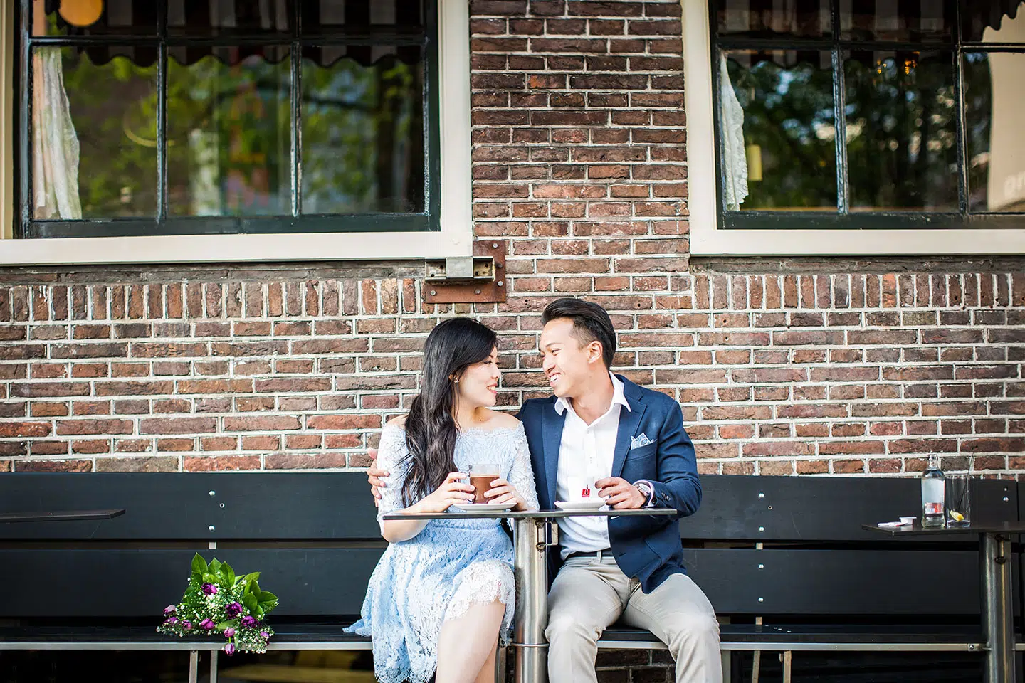 Prewedding couple having a cup of hot chocolate in the streets of Amsterdam