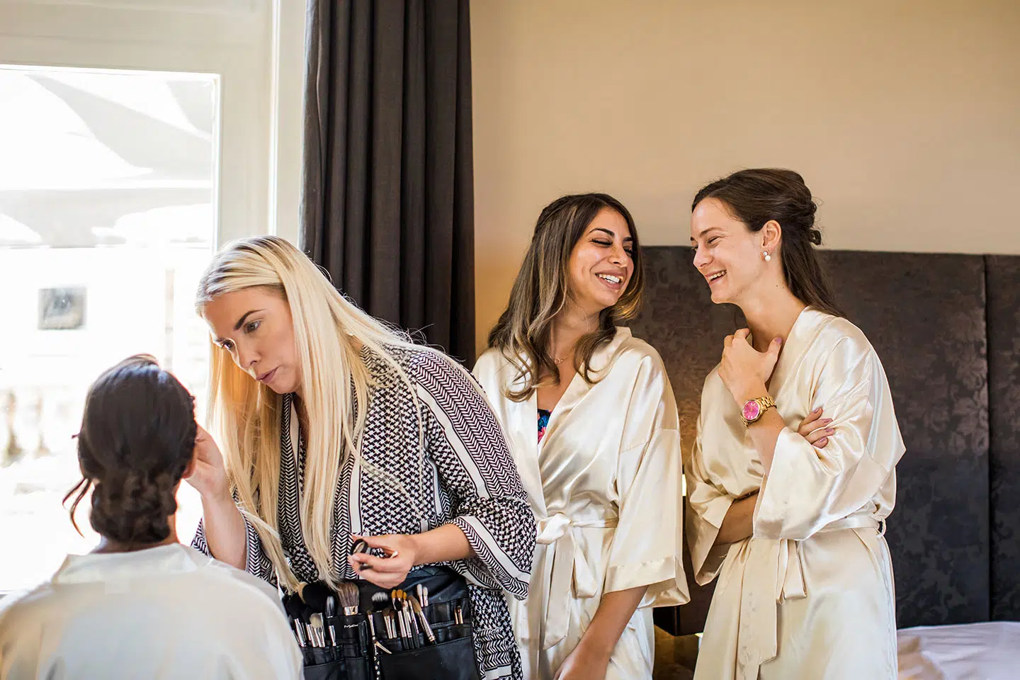 Bruid met vriendinnen in de make-up tijdens bruiloft bij Kasteel de Hooge Vuursche