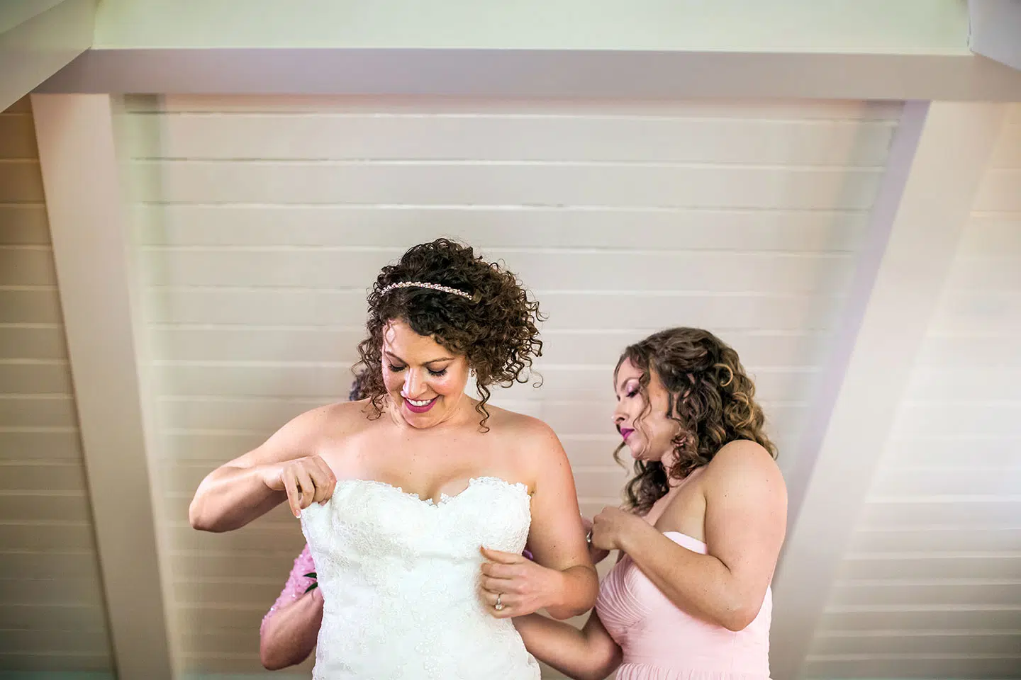 Bride putting her dress on