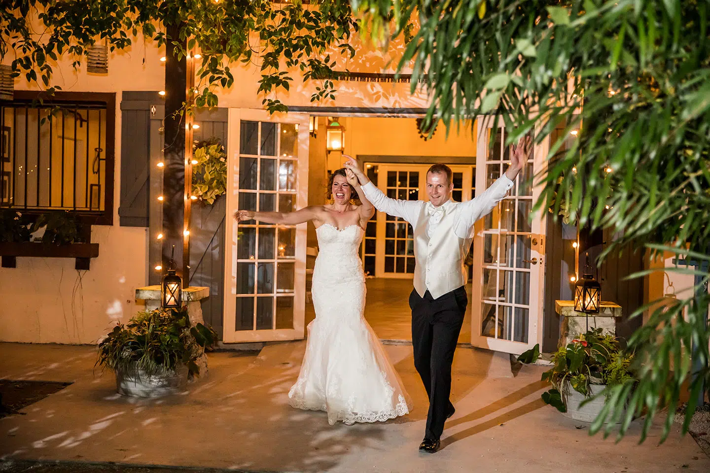 Bridal couple gets cheered on during their entrance at the party